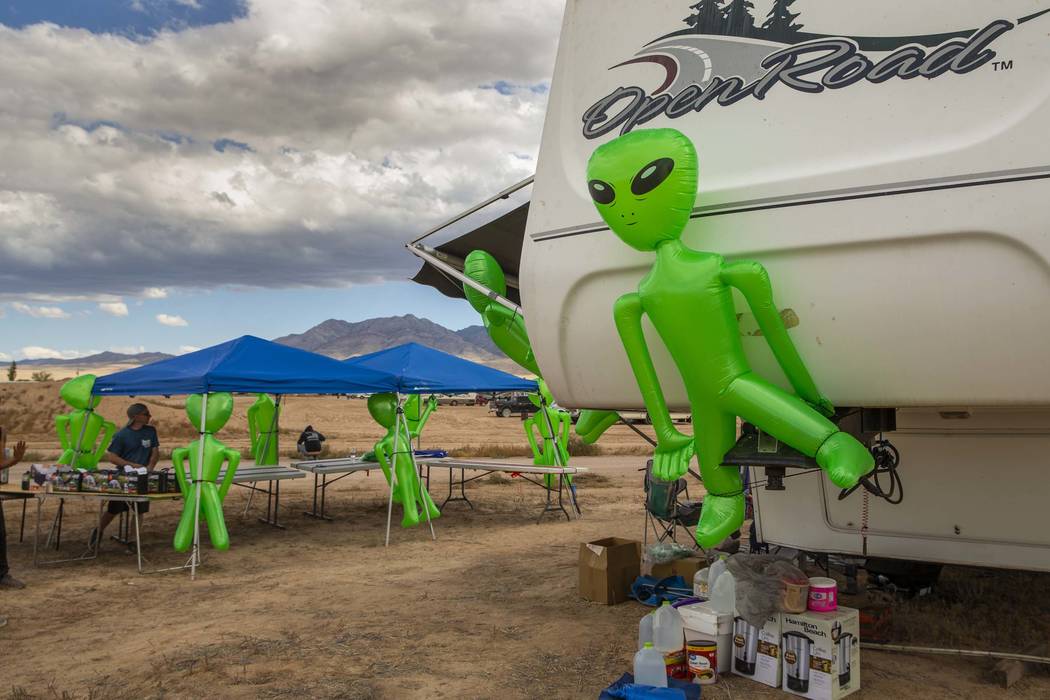 Aliens hang on a merchandise and supply tent as the start of the Alienstock festival nears on T ...