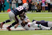 New England Patriots outside linebackers Jamie Collins (58) and Elandon Roberts (52) sack Miami ...