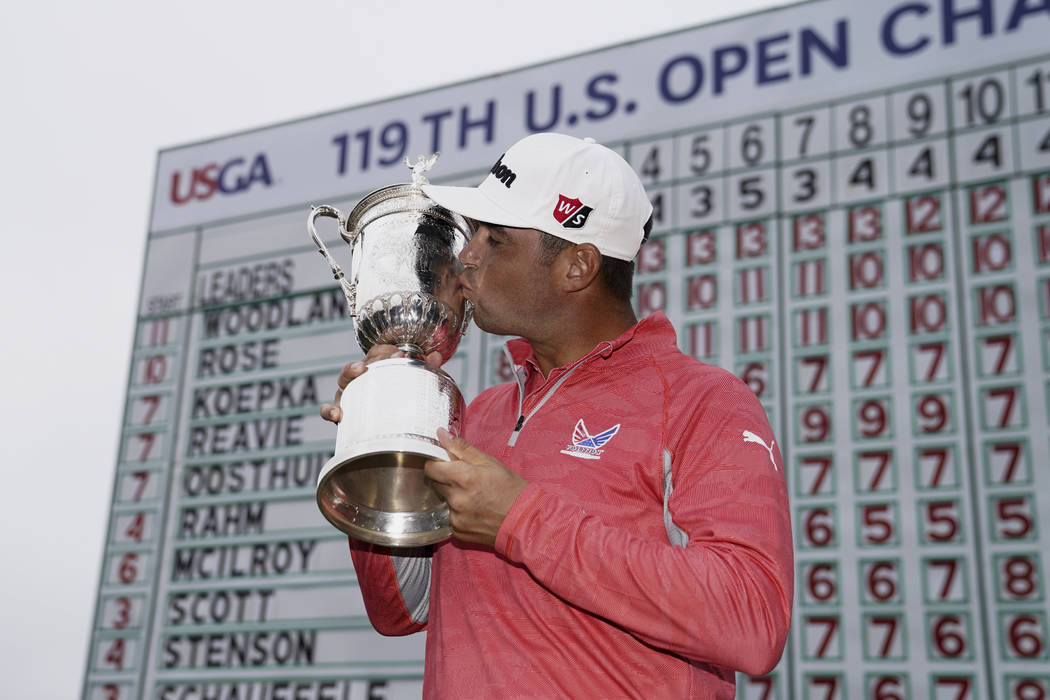 Gary Woodland posses with the trophy after winning the U.S. Open Championship golf tournament S ...