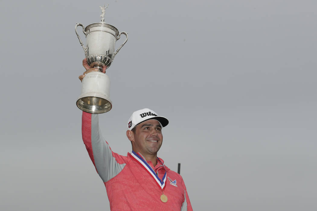 Gary Woodland celebrates with the trophy after winning the U.S. Open Championship golf tourname ...