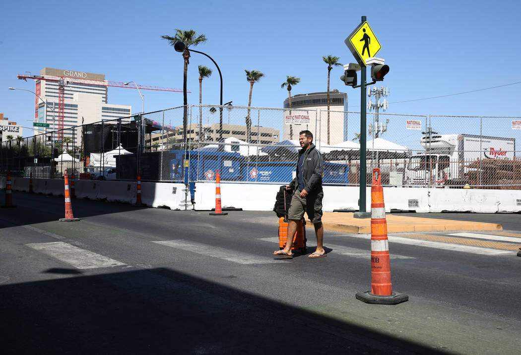 A guest at El Cortez Cabana Suites navigates through Ogden Street where the street is closed fo ...