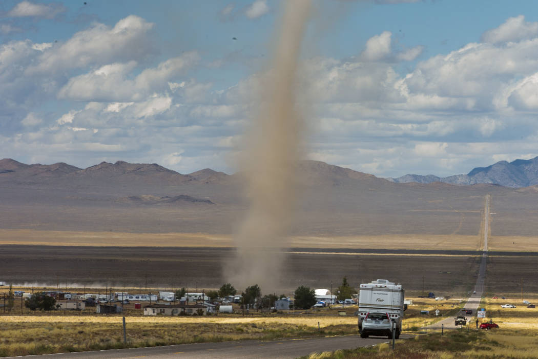 Large dust devil kicks up debris as it passes through Rachel off of state Route 375 as preparat ...