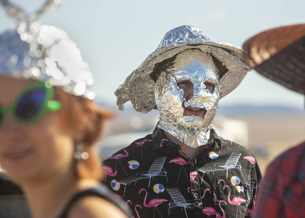 Chris Reid of Reno makes tinfoil hats for festivalgoers during the Alienstock festival on Frida ...