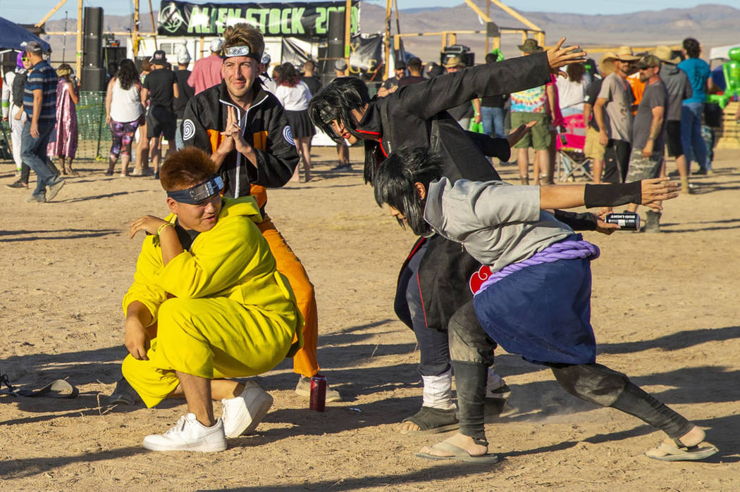 Festivalgoers strike the Naruto run pose and others during the Alienstock festival on Friday, S ...