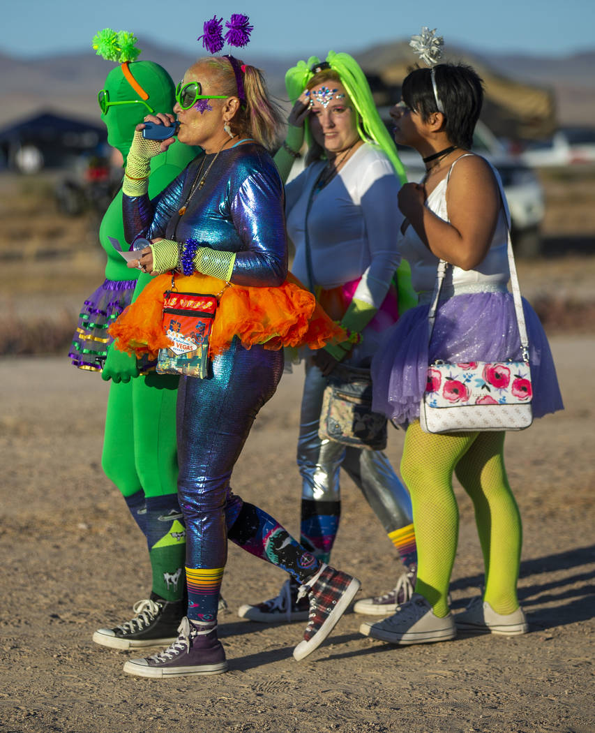 Festivalgoers are costumed up and wander about the grounds during the Alienstock festival on Fr ...