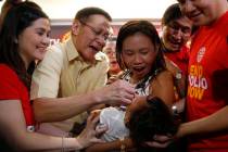 Philippine Health Secretary Francisco Duque III, second from left, administers anti-polio vacci ...