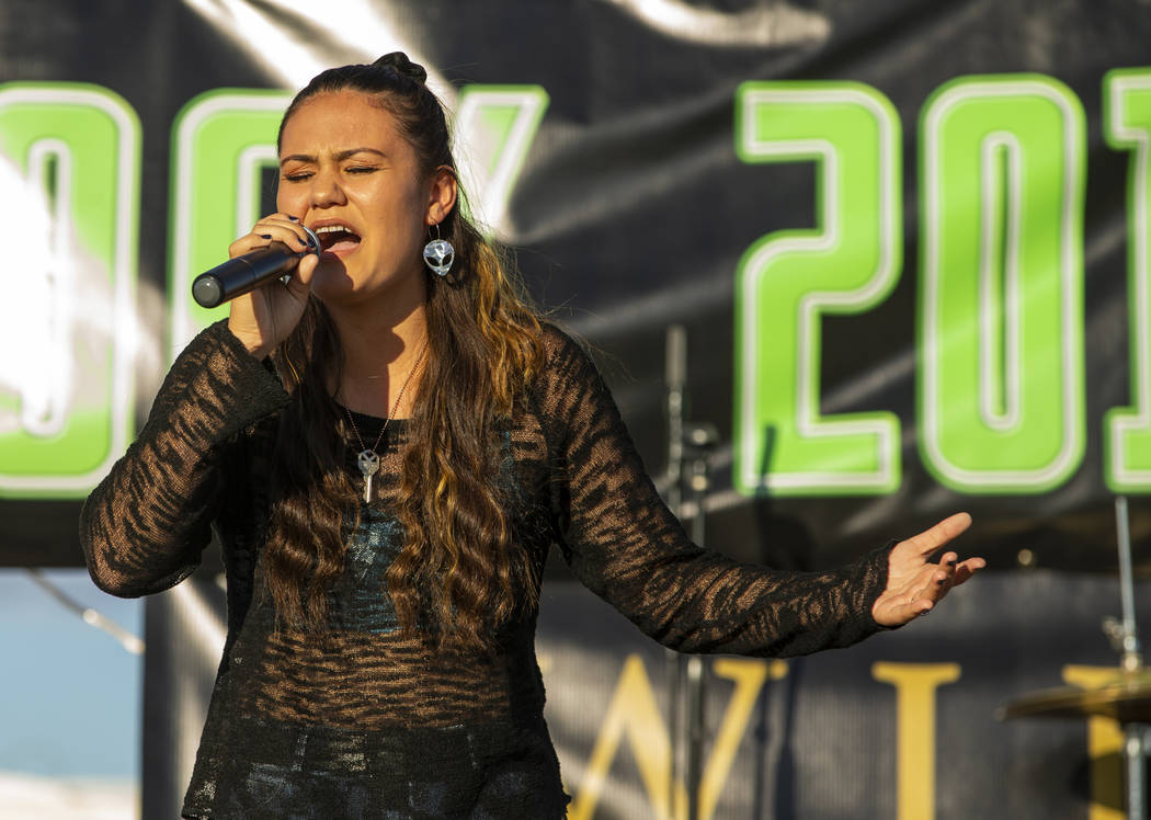 Performer Elyse sings for the crowd on the main stage during the Alienstock festival on Friday, ...