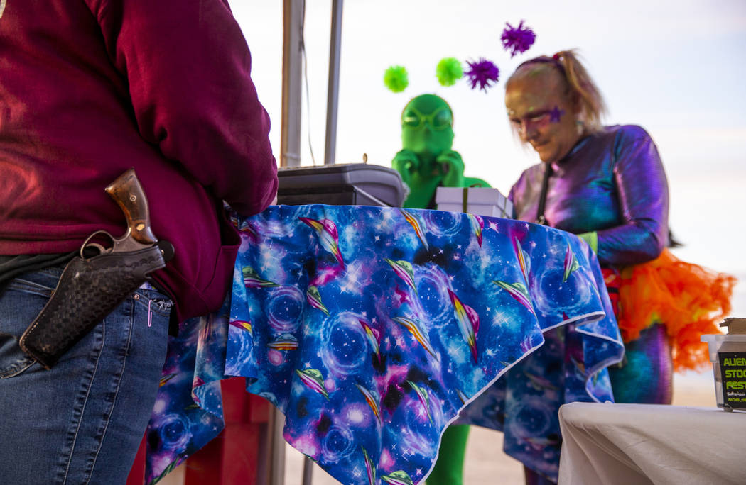 Samantha Travis, left, with the Little A'Le'Inn sells more merchandise to customers during the ...