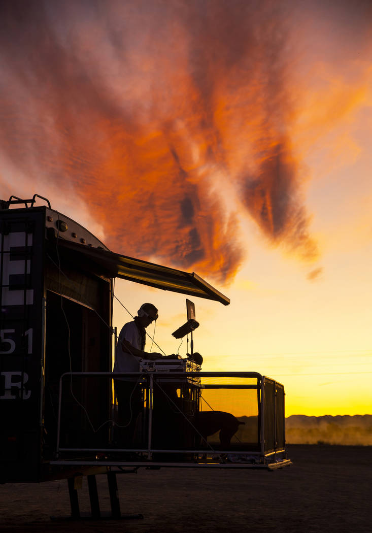 DJ Karn Elofson of Sweden plays into the sunset on his own small stage off of the festival grou ...