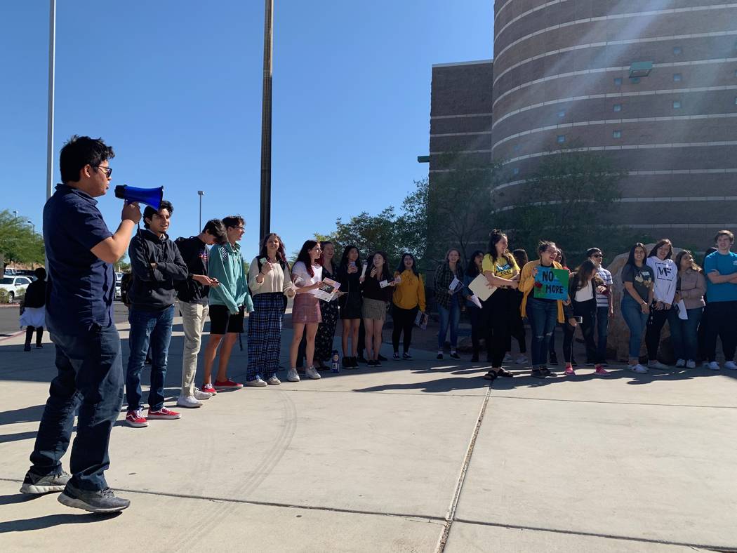 Palo Verde High School senior Dexter Lim, left, leads his peers in a chant during a global clim ...