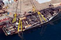 In a Sept. 12, 2019, file photo, the burned hull of the dive boat Conception is brought to the ...