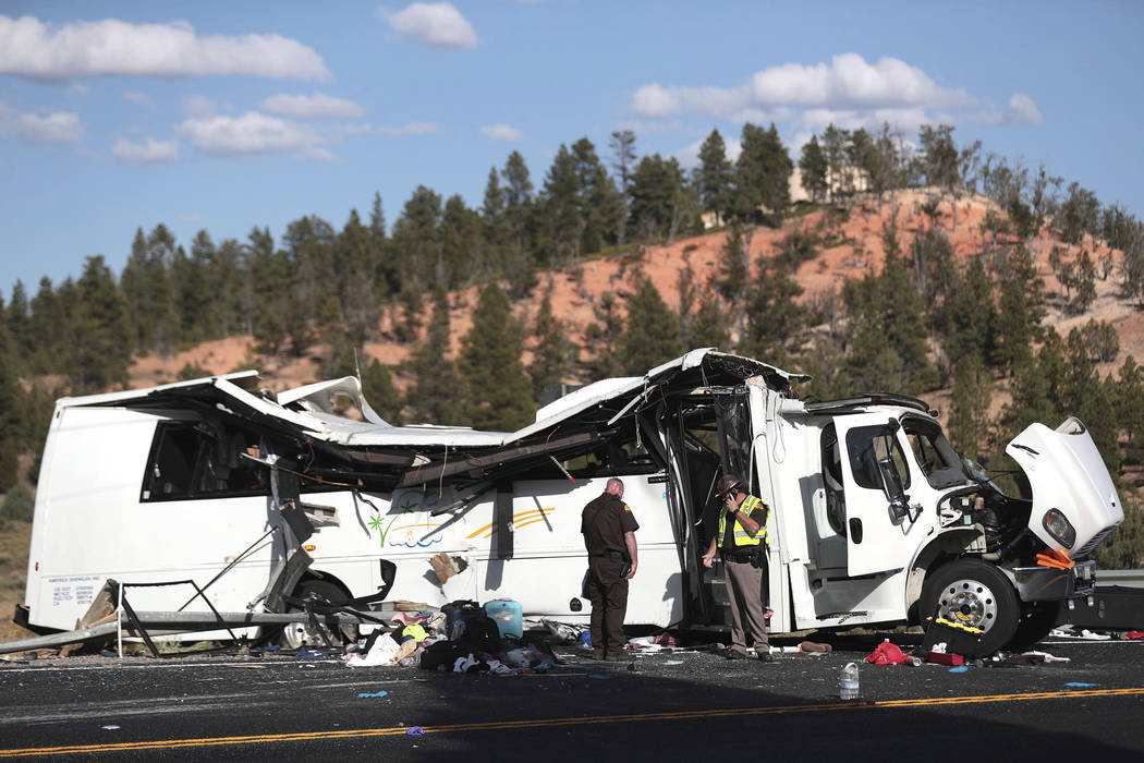 Authorities work the scene where at least four people were killed in a tour bus crash near Bryc ...
