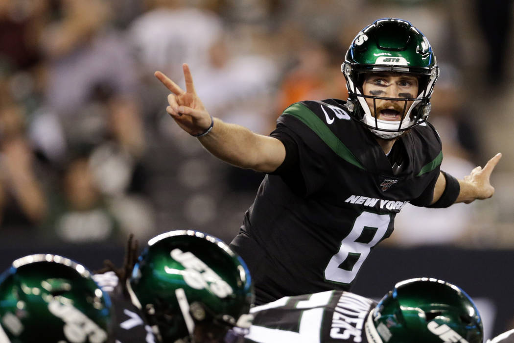 New York Jets' quarterback Luke Falk signals at the line of scrimmage during the second half ag ...
