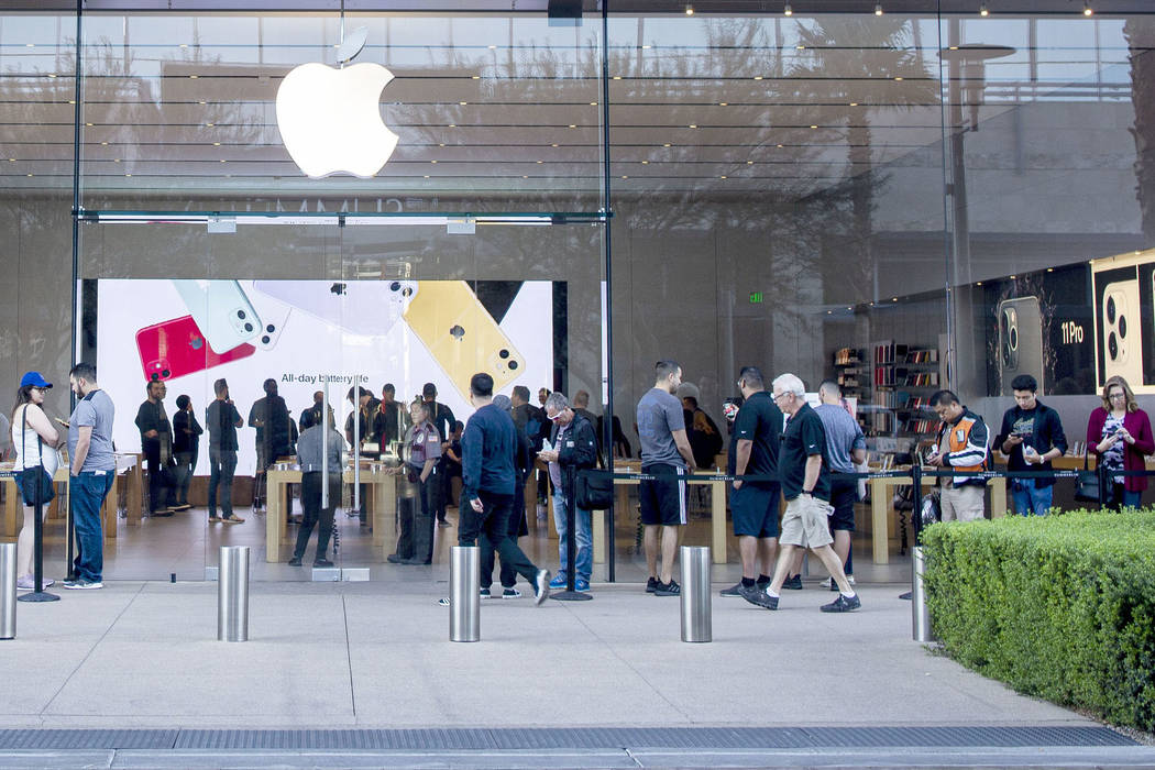 Individuals stand in line for the release of the new iPhone 11 at the Apple Store at Downtown S ...