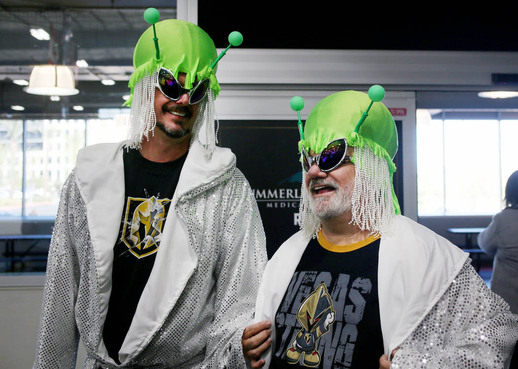 Las Vegas locals Andrew Jason, left, Michael Maybee watch the Golden Knights practice during an ...