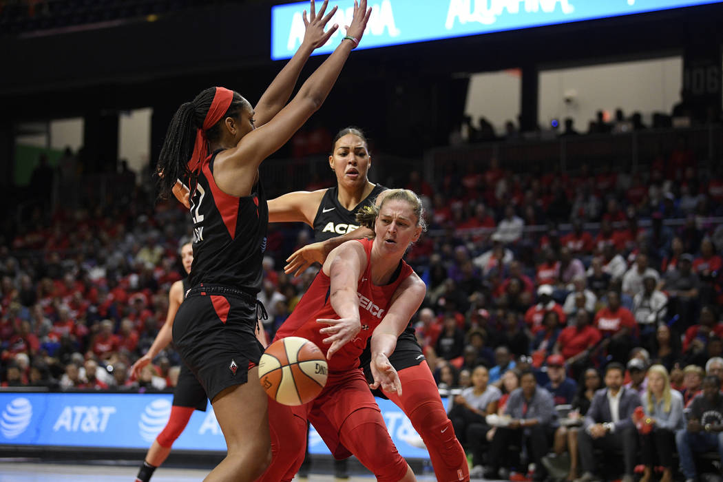 Washington Mystics center Emma Meesseman, right, passes th ball against Las Vegas Aces center A ...