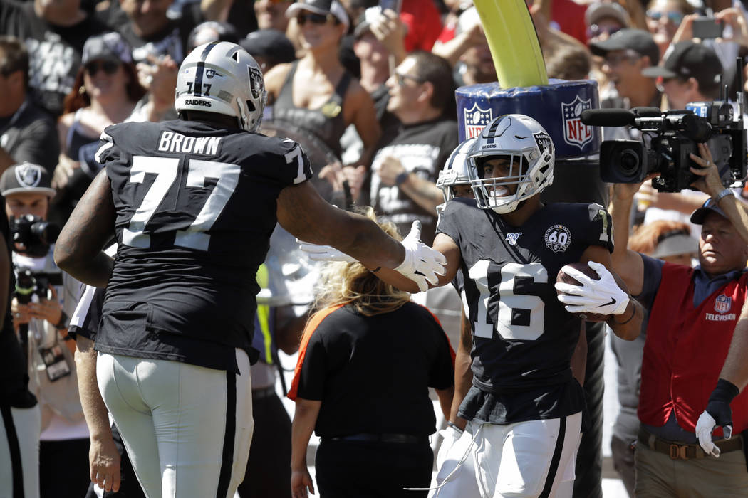 Oakland Raiders wide receiver Tyrell Williams (16) is greeted by offensive tackle Trent Brown ( ...