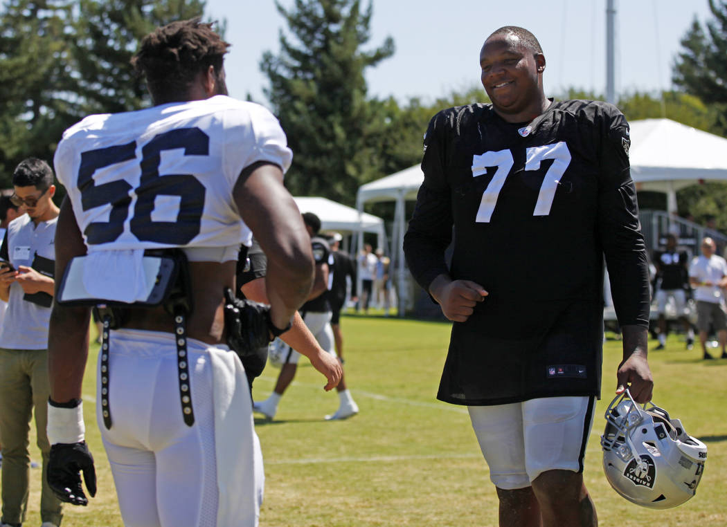 Oakland Raiders offensive tackle Trent Brown (77) meets with Los Angeles Rams defensive end Dan ...