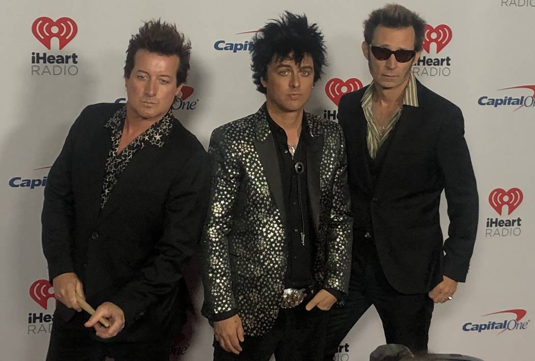 Tre Cool, Billie Joe Armstrong and Mike Dirnt of Green Day are shown on the red carpet at iHear ...