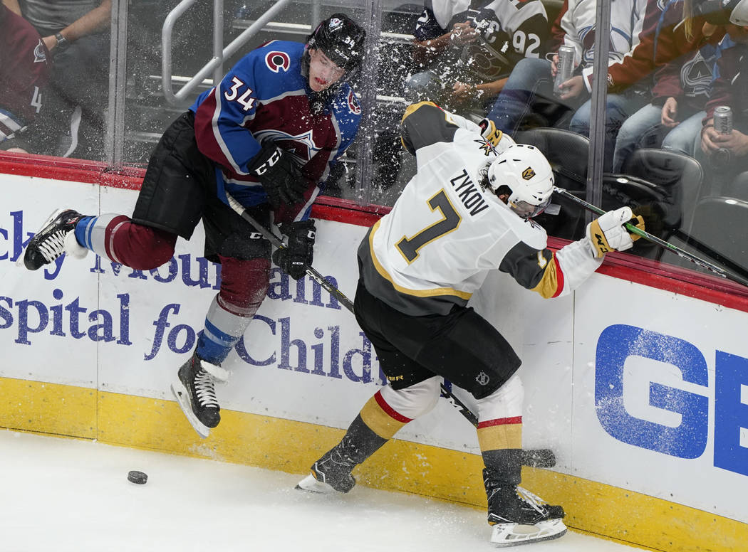 Vegas Golden Knights left wing Valentin Zykov (7) crashes into the boards with Colorado Avalanc ...
