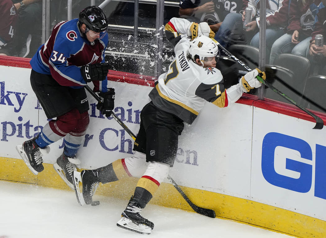 Vegas Golden Knights left wing Valentin Zykov (7) crashes into the boards with Colorado Avalanc ...