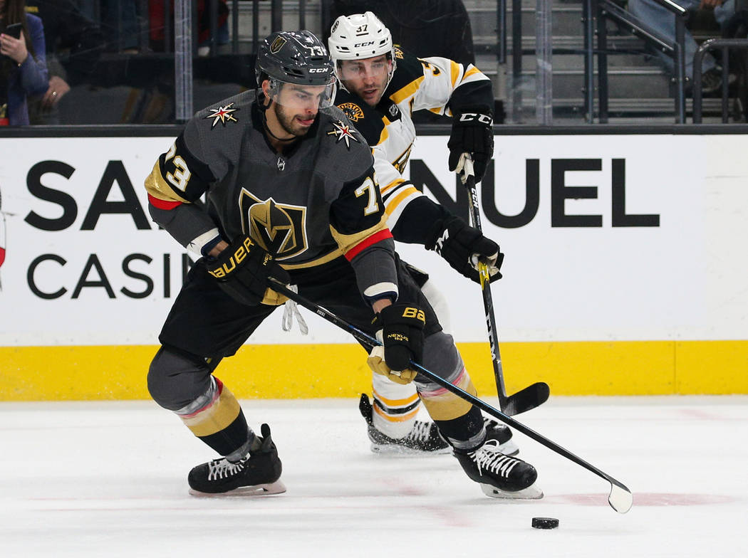 Vegas Golden Knights center Brandon Pirri (73) moves with the puck while being guarded by Bosto ...