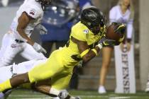 Oregon's Jaylon Redd, right, dives into the end zone for a touchdown against Montana during the ...