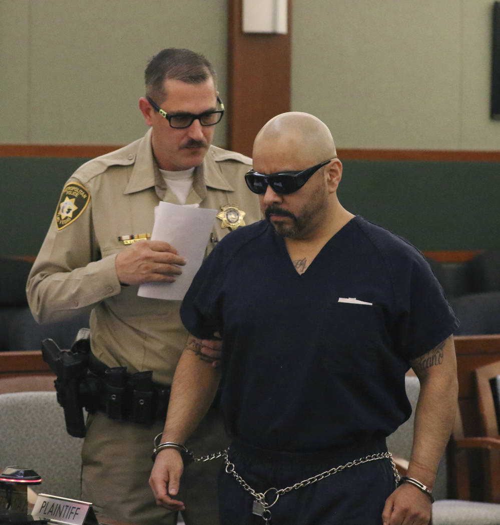 Gustavo Ramos-Martinez, convicted of killing two elderly people in 1998, is led into the courtr ...