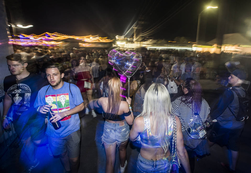 Festivalgoers make their way to the downtown stage during the first day of Life is Beautiful fe ...