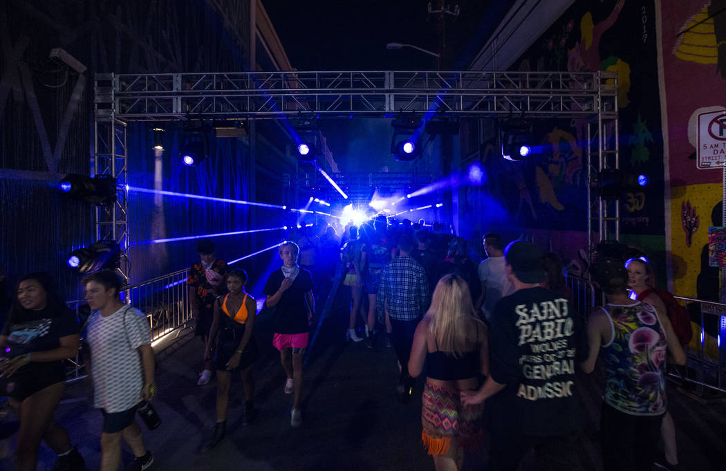 Attendees pass through an illuminated walkway during the first day of the Life is Beautiful fes ...