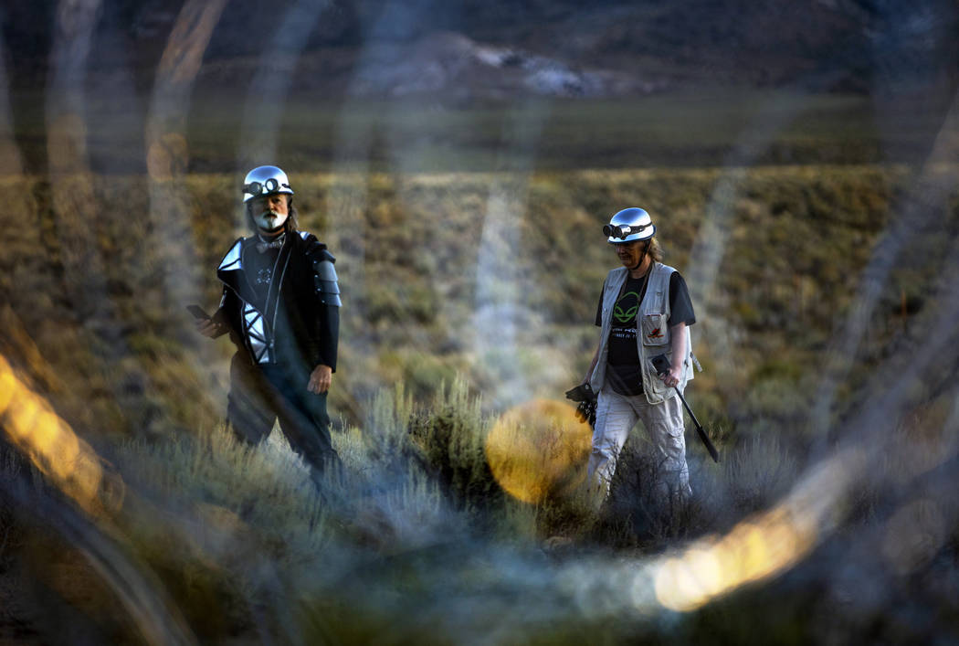 Matthew Devlen and Kim Dillinger Davis walk along the fence line with razor wire at the back ga ...