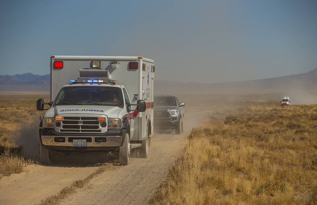 Emergency and medical personnel run code from the scene of a vehicle rollover with injuries on ...
