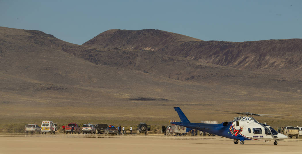 A Mercy Air helicopter prepares to lift off with two injured in a vehicle rollover on the salt ...