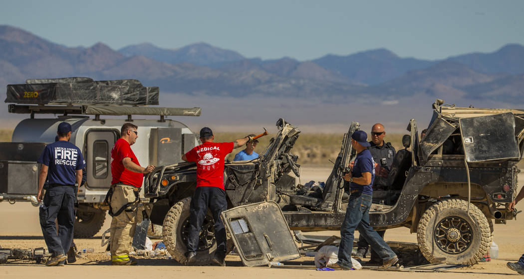 Emergency and medical personnel work the scene of a vehicle rollover with injuries on the salt ...