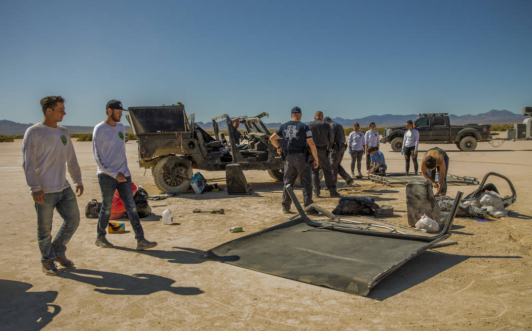 Festivalgoers connected to the scene of a vehicle rollover are assisted by emergency and medica ...