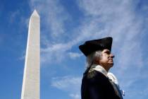 John Lopes, playing the part of President George Washington, stands near the Washington Monumen ...