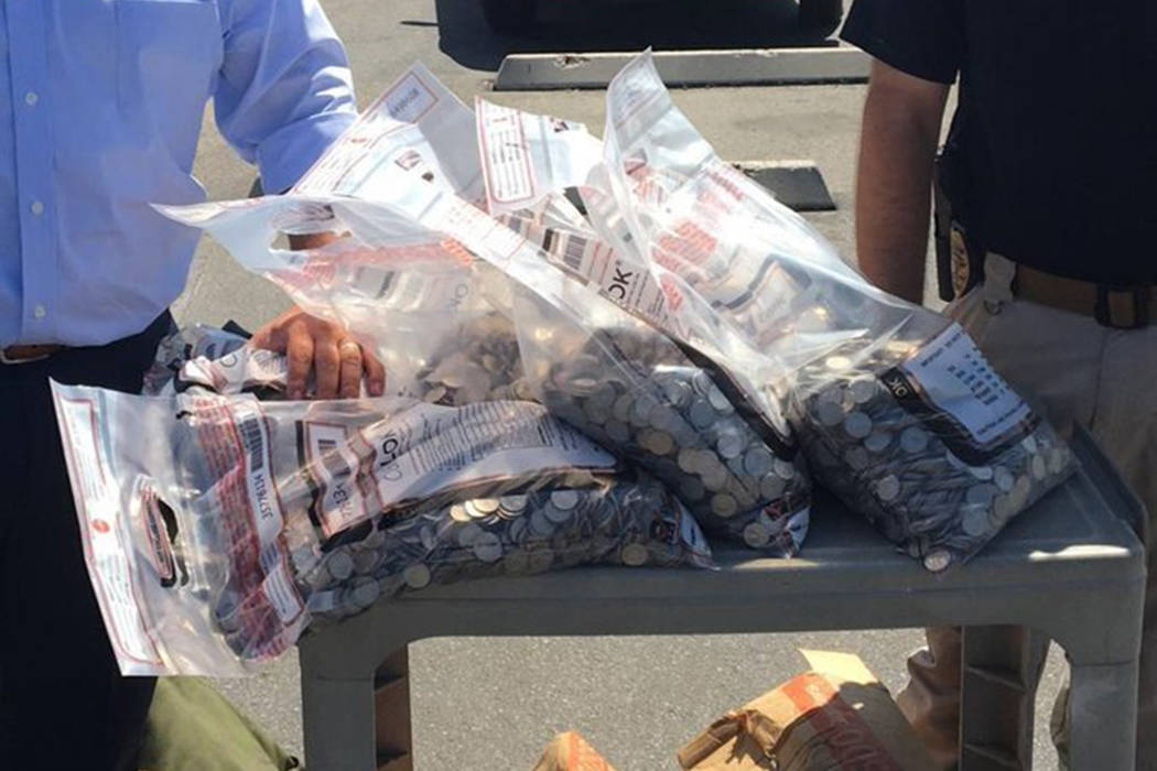 This undated photo provided by the Bakersfield Police Department shows $6,000 worth of quarters ...