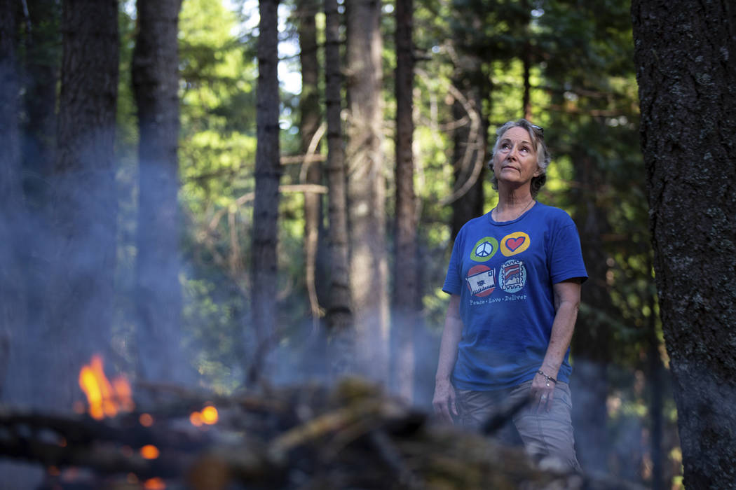 In this photo taken June 13, 2019, is Kelly Loew creating a defensible space around her home in ...