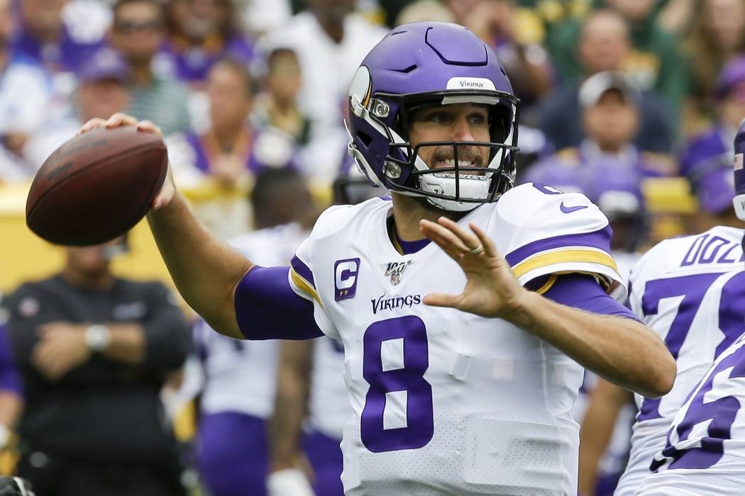 Minnesota Vikings' Kirk Cousins throws during the first half of an NFL football game against th ...