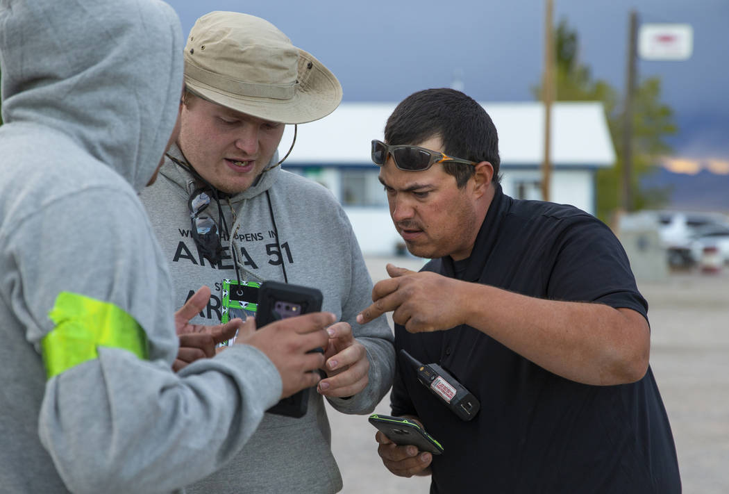 Volunteers Javy Morales, from left, and Brandon Misciagna work on parking details with Cody The ...