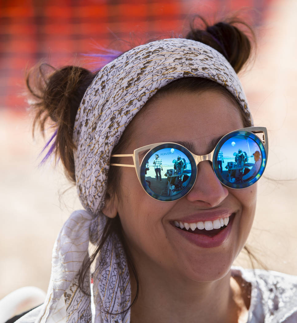 Marissol Martins of Los Angeles laughs with friends in her t-shirt stencil booth during the Ali ...