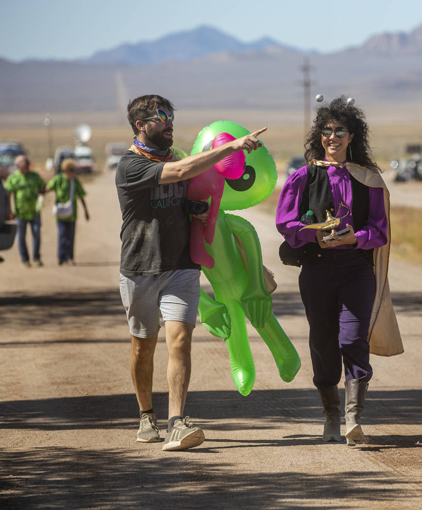 UNICULT members walk up the frontage road carrying aliens and a magic lamp during the Alienstoc ...