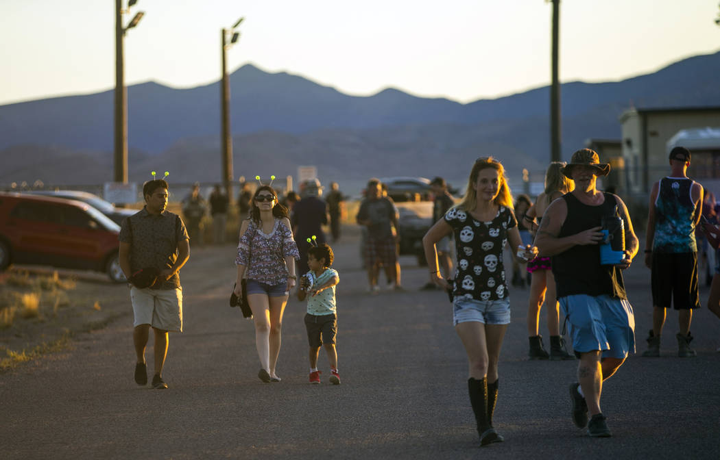 Visitors walk away from the back gate of Area 51 during the Alienstock festival on Saturday, Se ...
