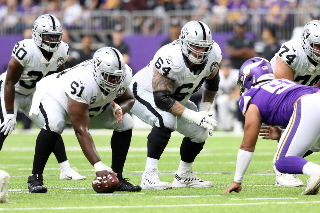 Oakland Raiders center Rodney Hudson (61) prepares to hike the football as guard Richie Incogni ...