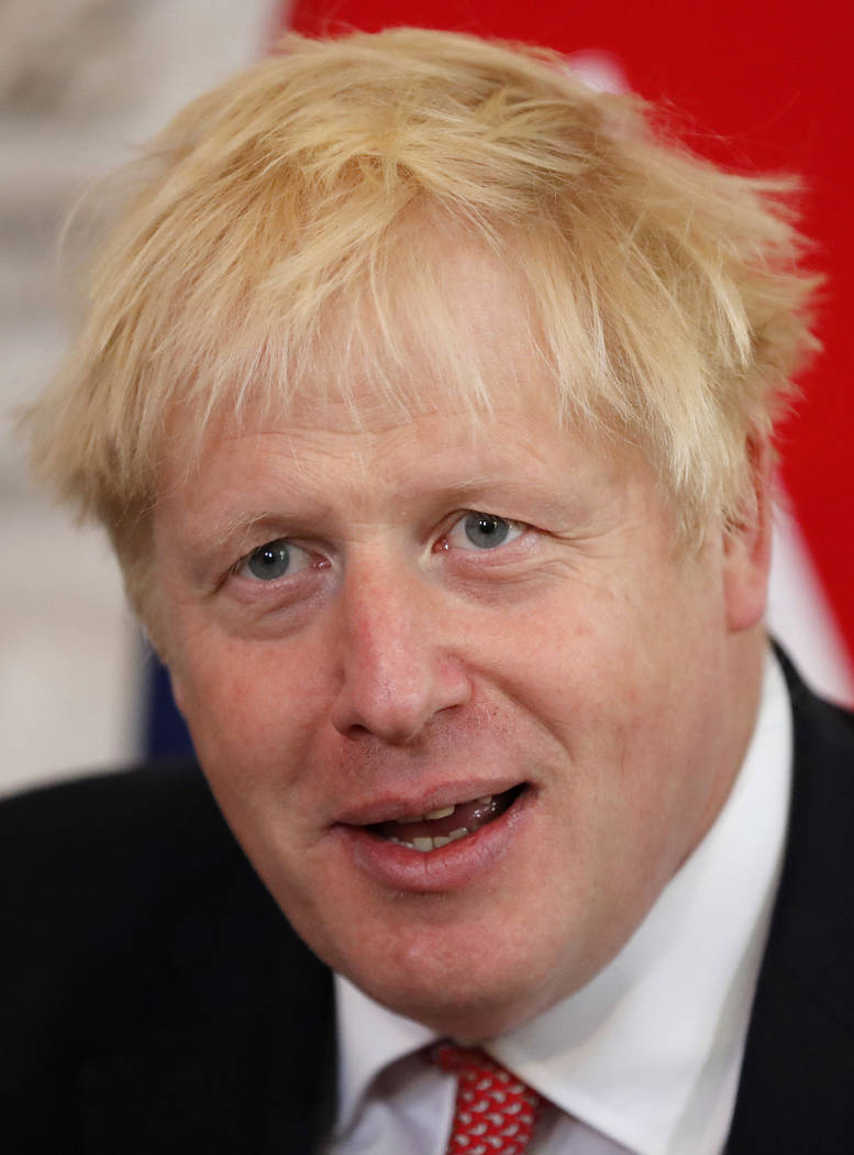 Britain's Prime Minister Boris Johnson sits down to welcome the Emir of Qatar, Sheikh Tamim bin ...