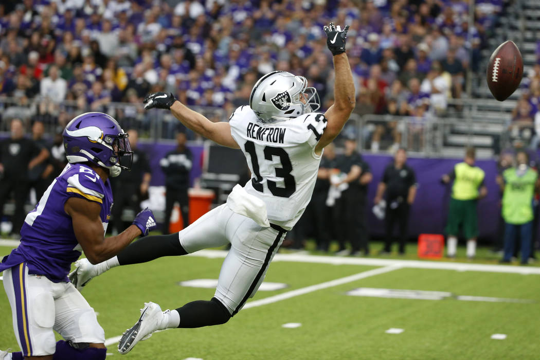 Minnesota Vikings cornerback Mike Hughes, left, breaks up a pass intended for Oakland Raiders w ...
