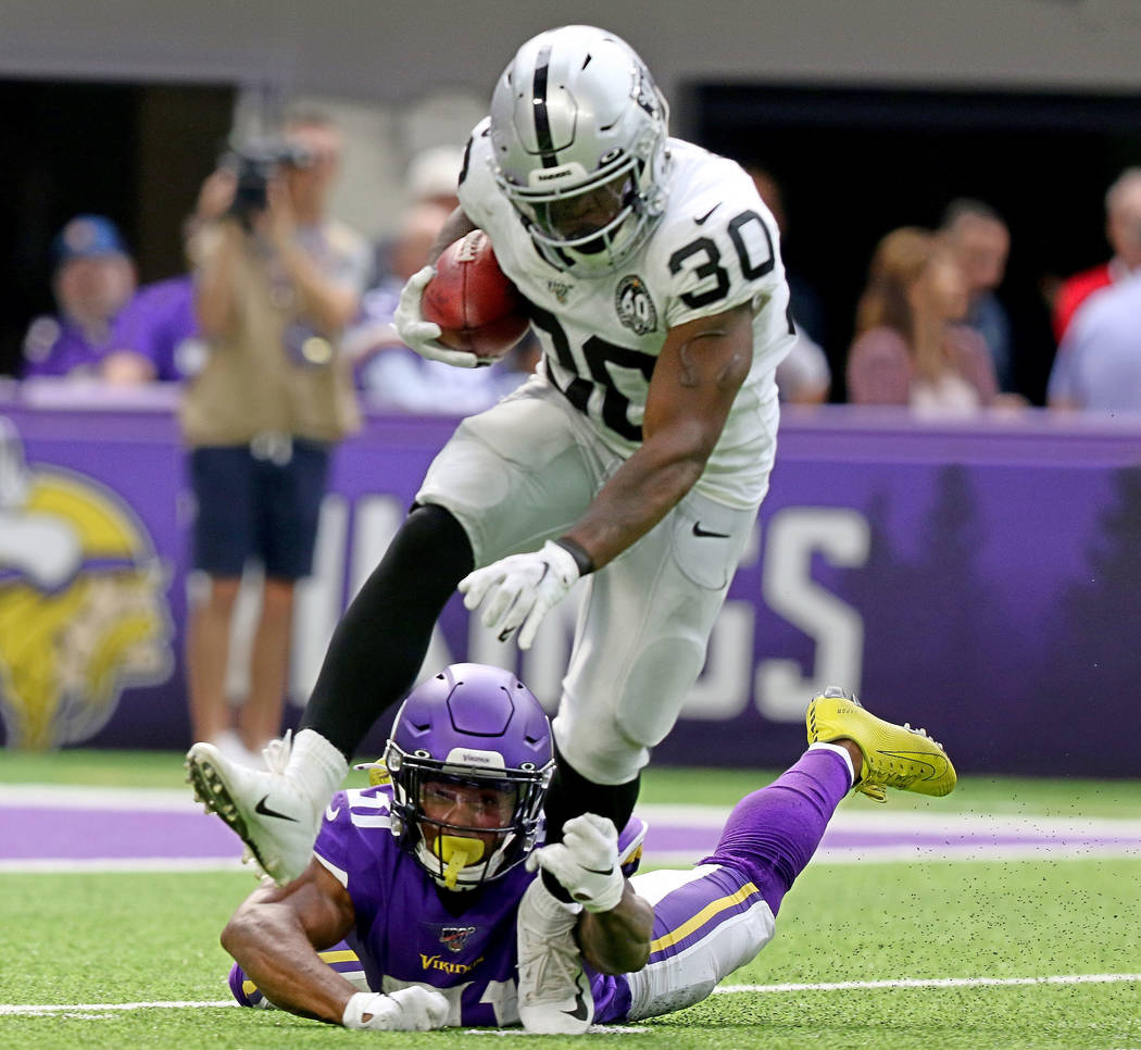 Oakland Raiders running back Jalen Richard (30) tries to shed a tackle from Minnesota Vikings r ...