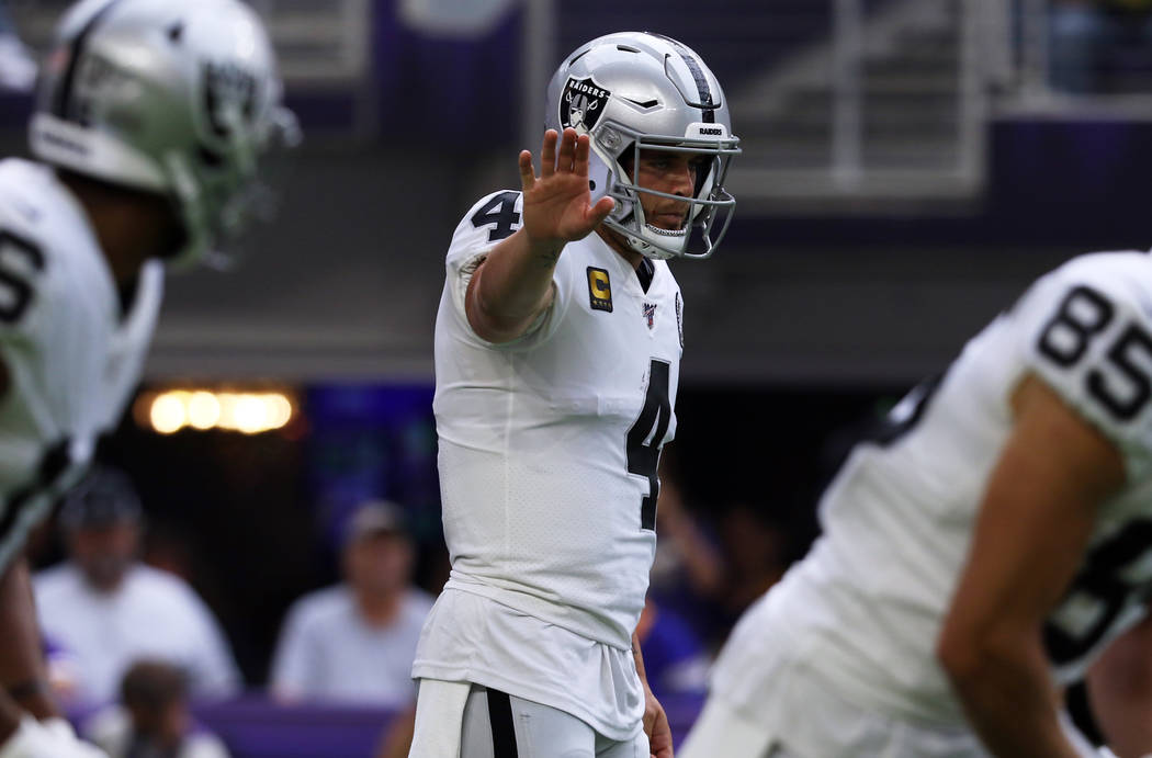 Oakland Raiders quarterback Derek Carr (4) calls a play during the first half of an NFL game ag ...