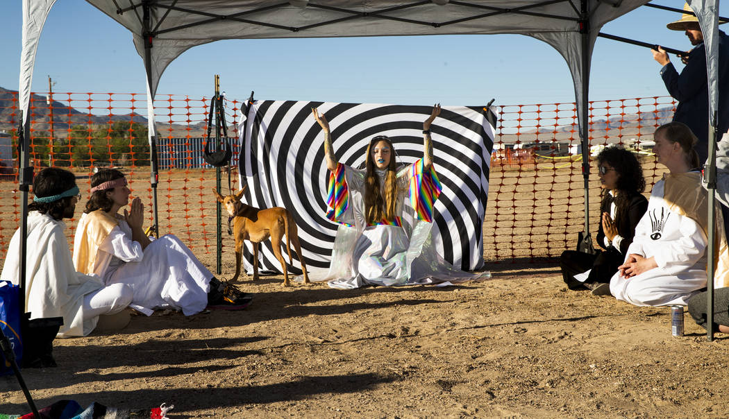 UNICULT leader Unicole, center, leads a morning prayer service for her members and festivalgoer ...