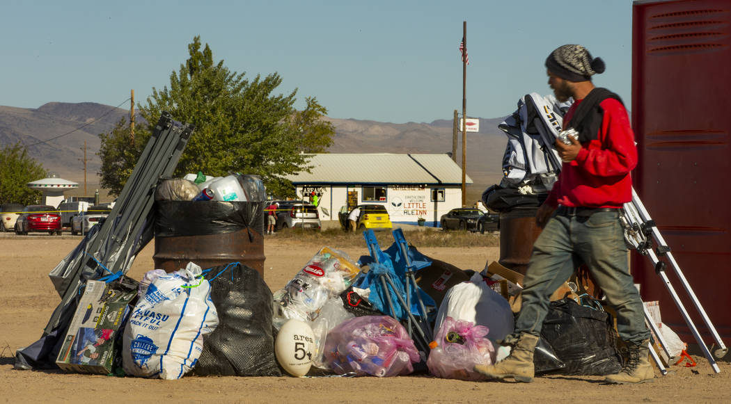 Trash is orderly stacked in the parking area across from the Little A'Le'Inn as festivalgoers d ...